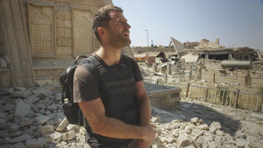 Journalist Ben Anderson stands among bombed ruins in Mosul, Iraq. 