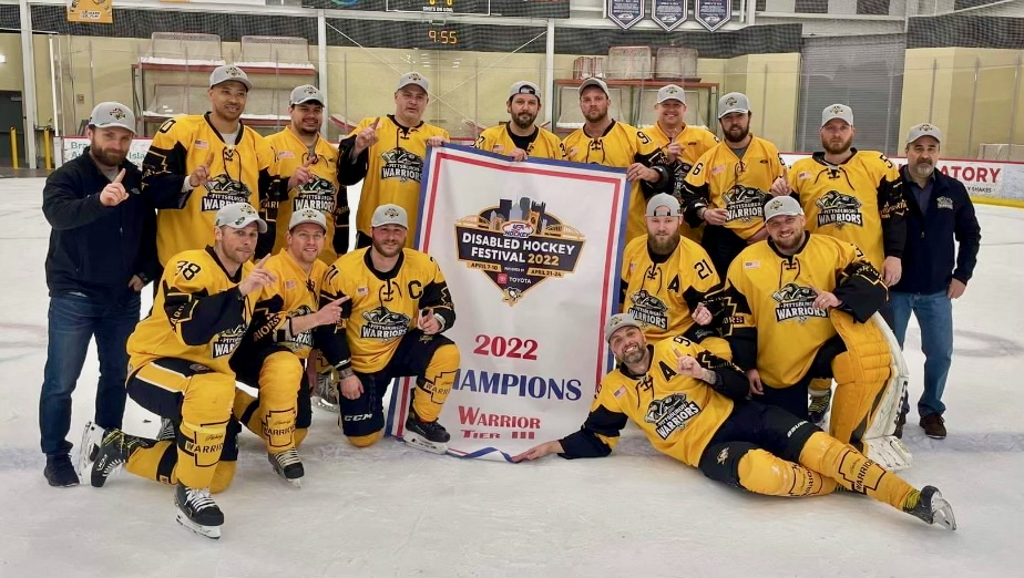 The Pittsburgh Warriors with the championship banner of the Disabled Hockey Festival 2022. 