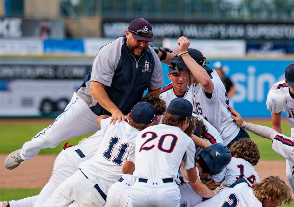 Coach Junker and the Titans celebrate after winning the PIAA championship. 