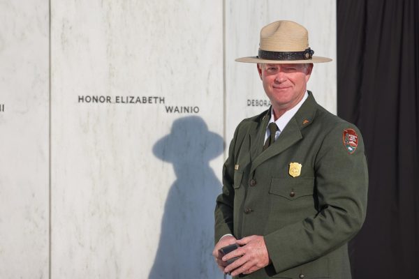 Superintendent Steven Clark poses in front of the Wall of Names at the Flight 93 National Memorial. 

