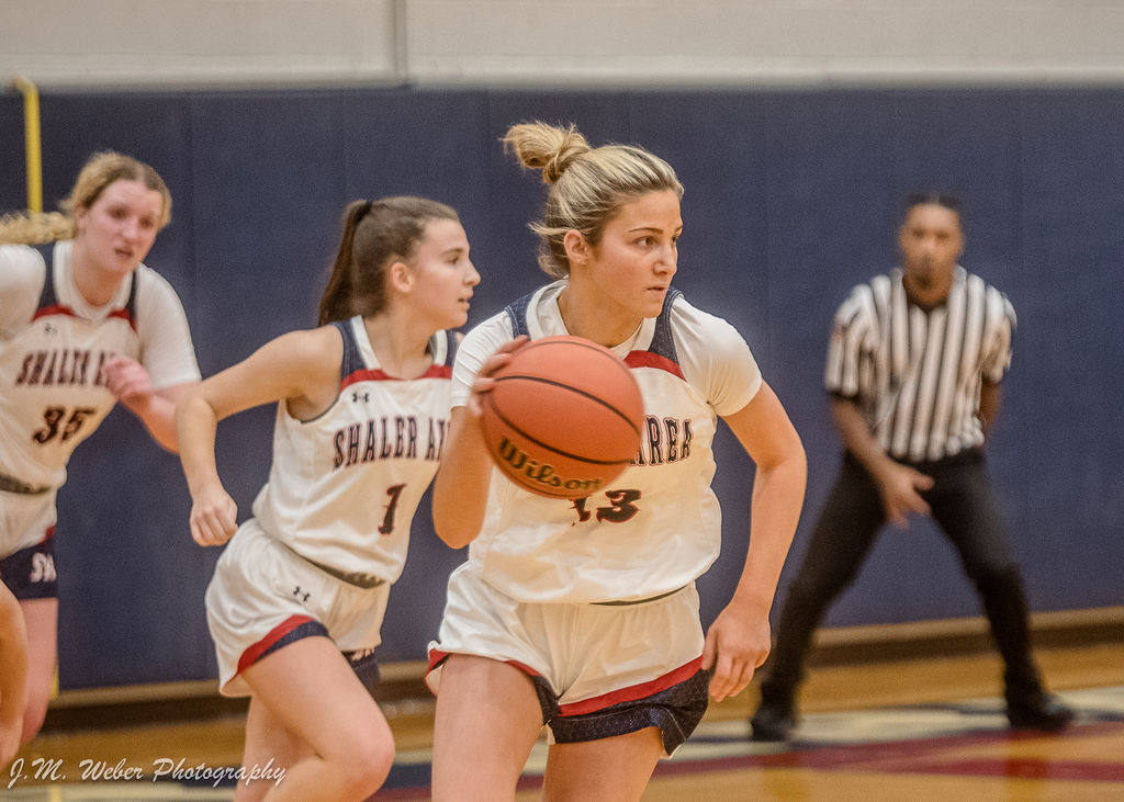 Senior Hilary Quinn (#13) brings the ball up the court, trailed by Bayleigh Perez (#1) and Jorja Bernesser (#35).