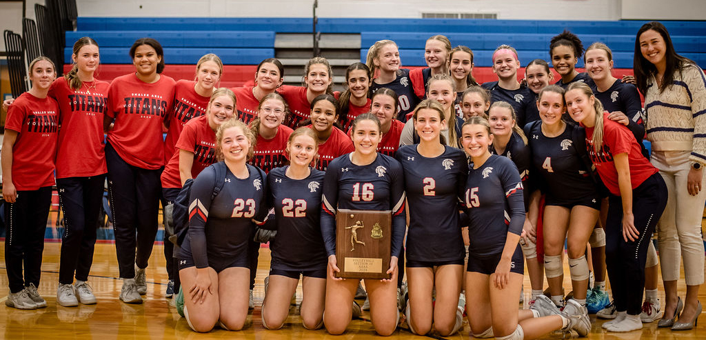 The girls volleyball team with the section championship plaque